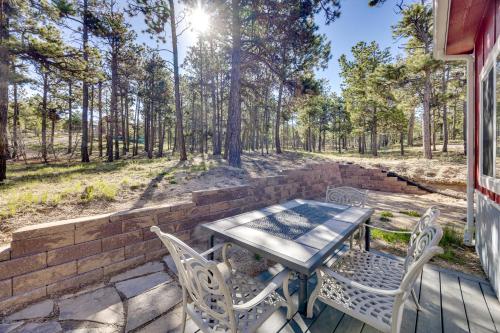 a patio with a table and chairs on a brick wall at 13 Mi to USAFA Peaceful Colorado Springs Getaway! in Gleneagle