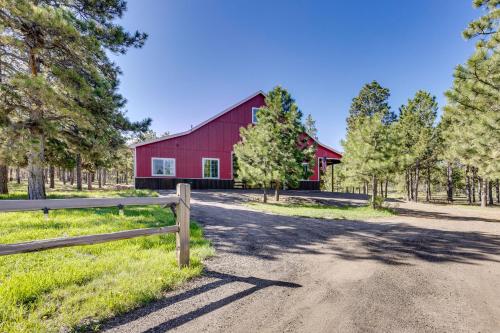 a red barn with a fence on a dirt road at 13 Mi to USAFA Peaceful Colorado Springs Getaway! in Gleneagle