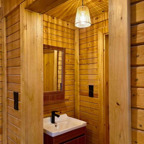 a bathroom with a sink and a mirror at أكواخ القرية -VILLAGE HUTs in Taif