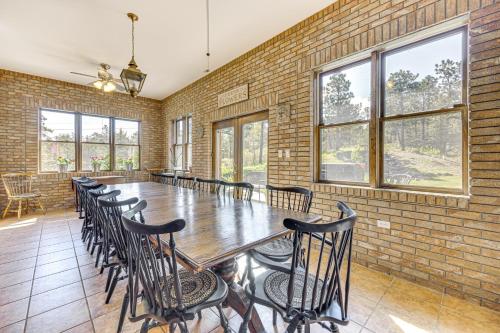 a large room with a brick wall and a table and chairs at Pikes Peak View - Mtn Home in Colorado Springs! in Gleneagle