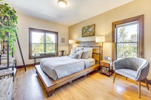 a bedroom with a bed and a chair and windows at Pikes Peak View - Mtn Home in Colorado Springs! in Gleneagle
