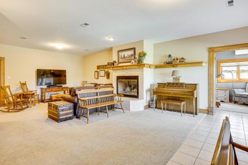 a living room with a fireplace and a piano at Pikes Peak View - Mtn Home in Colorado Springs! in Gleneagle