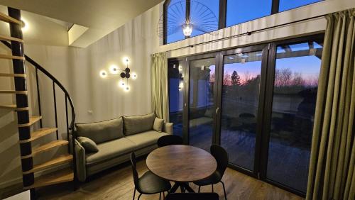 a living room with a couch and a table at Osada Mech i Fale in Tarnobrzeg