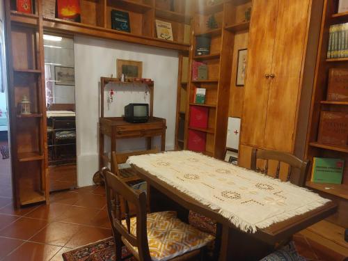 a dining room with a table and some shelves at Venus apartment in Venice