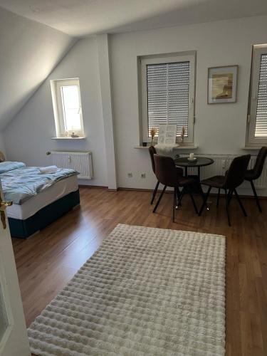 a bedroom with a bed and a table and chairs at Gemütliche Wohnung in Mesum in Rheine