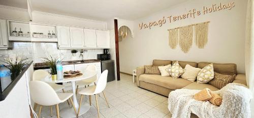 a kitchen and a living room with a couch and a table at Lovely apartment in Costa Adeje by Vapagó Tenerife in Playa Fañabe