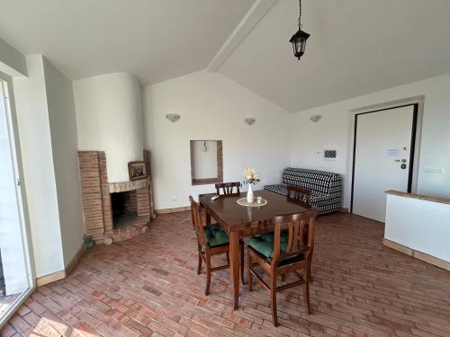 a dining room with a table and a fireplace at Il Casaletto in Palombara Sabina
