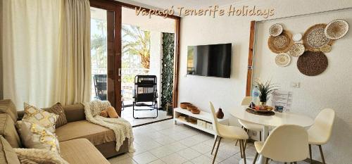 a living room with a couch and a table at Lovely apartment in Costa Adeje by Vapagó Tenerife in Playa Fañabe