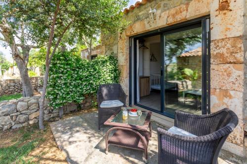 a patio with two chairs and a table at Agroturisme Es Racó De Maria in Maria de la Salut
