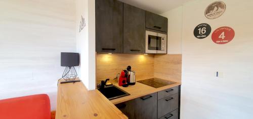 a kitchen with a sink and a counter top at Pieds des pistes - Parking couvert - Plein sud in L'Alpe-d'Huez