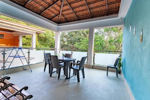 a dining room with a table and chairs at 3BHK Villa - The Blue Pearl Varca Beach in Varca