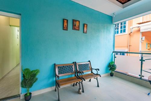 a bench in a room with a blue wall at 3BHK Villa - The Blue Pearl Varca Beach in Varca