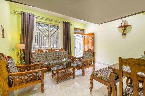 a living room with a couch and chairs and a table at 3BHK Villa - The Blue Pearl Varca Beach in Varca