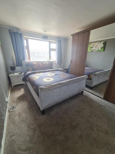 a bedroom with two beds and a window at The Rushdon in Grays Thurrock