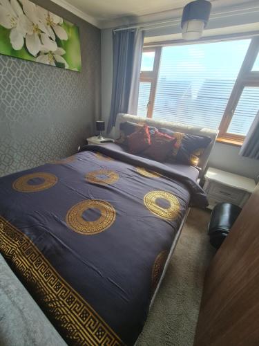 a bedroom with a large bed with a large window at The Rushdon in Grays Thurrock