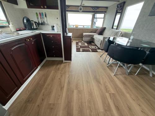 a kitchen and living room with a table and chairs at Caravan in Banff