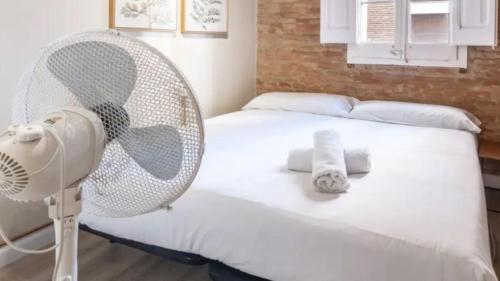 a white fan sitting on a bed in a bedroom at Seaview Villa in Apollonii Lefkada in Athanion