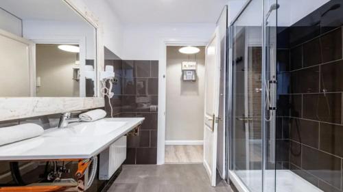 a bathroom with a sink and a glass shower at Seaview Villa in Apollonii Lefkada in Athanion