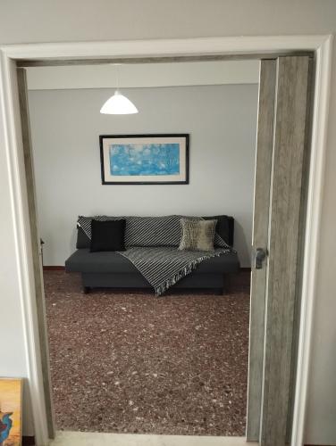 a living room with a couch in a room at Dim-Paul in Artemida