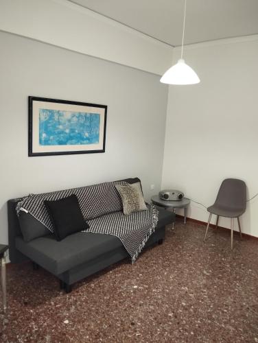 a living room with a couch and a table at Dim-Paul in Artemida