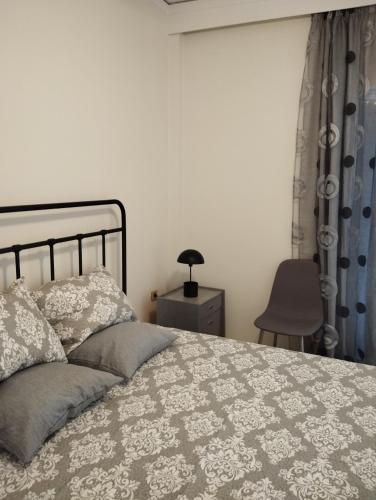 a bedroom with a bed and a table and a chair at Dim-Paul in Artemida