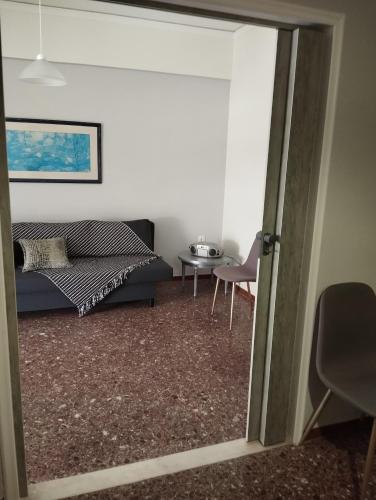 a living room with a bed and a table at Dim-Paul in Artemida