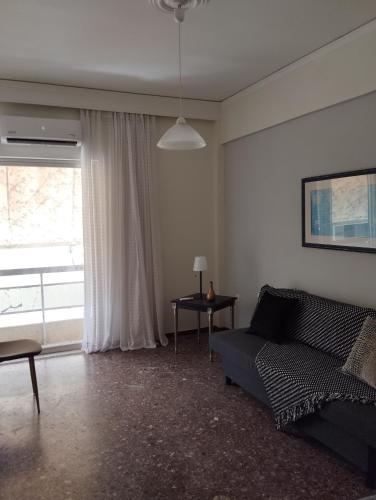 a living room with a couch and a window at Dim-Paul in Artemida