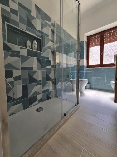 a bathroom with a shower with a glass door at Il MaRe dei delfini in Ladispoli