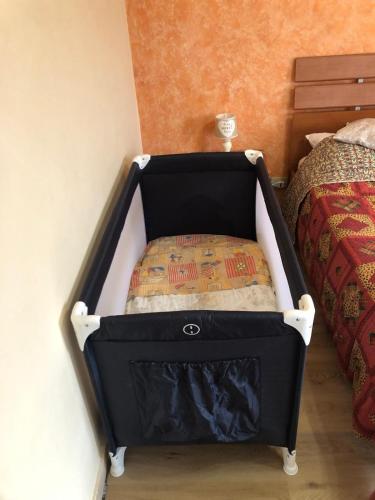 a black and white crib in a bedroom at Nichi & Matti Iemmolo's Guest House in Campofelice di Roccella
