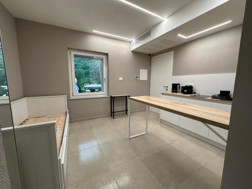 an empty room with a table and a window at IsabellaGuestHouse in Chiusa di Pesio