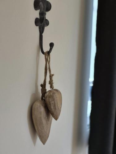 a pair of hearts hanging on a wall at La Ferme de la Cour in Herbeumont