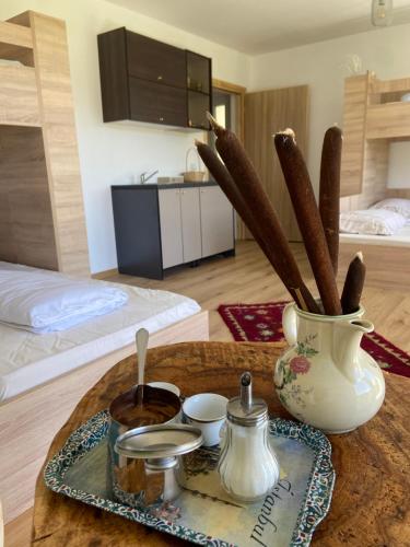 a coffee table with a vase and a tray of food at Konak Umoljani in Umoljani