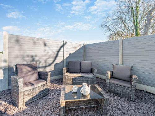 two chairs and a coffee table on a patio at 2 Bed in Aberaeron 94044 in Henfynyw Upper