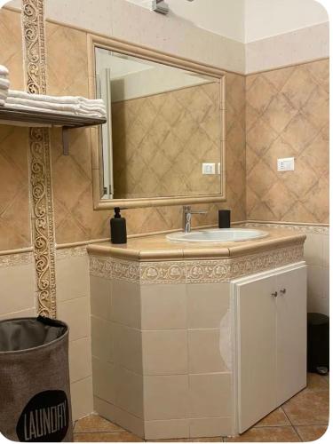 a bathroom with a sink and a mirror at Anna House in Fiumicino