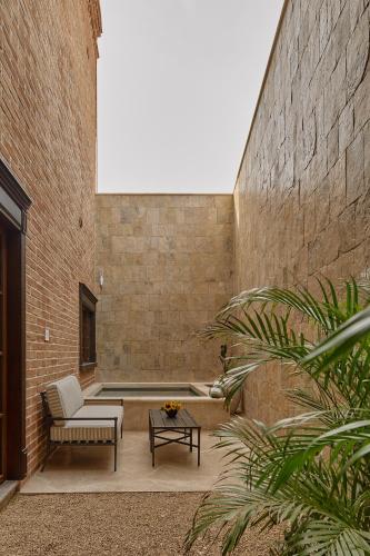 a courtyard with a couch and a coffee table at Todos Santos Boutique Hotel in Todos Santos