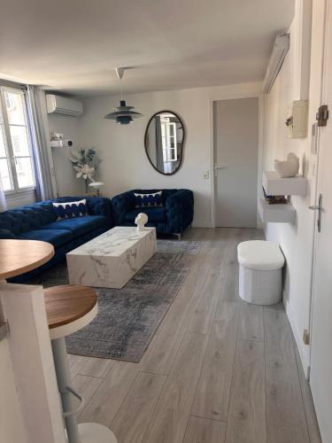 un salon avec un canapé bleu et une table dans l'établissement 2 pieces Antibes, à Antibes