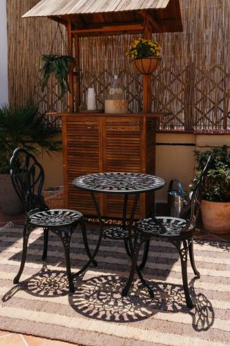 two chairs and a table and a table and two chairs at Hotel du Temps Madrid in Madrid