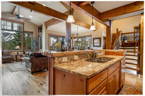 a kitchen with a sink and a living room at Dreamcatcher a spacious Five bedroom home in Winter Park Colorado in Winter Park