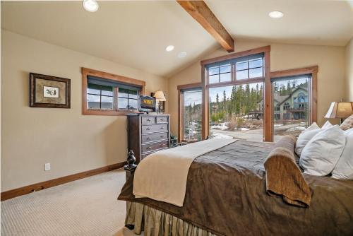 a bedroom with a large bed and a window at Dreamcatcher a spacious Five bedroom home in Winter Park Colorado in Winter Park
