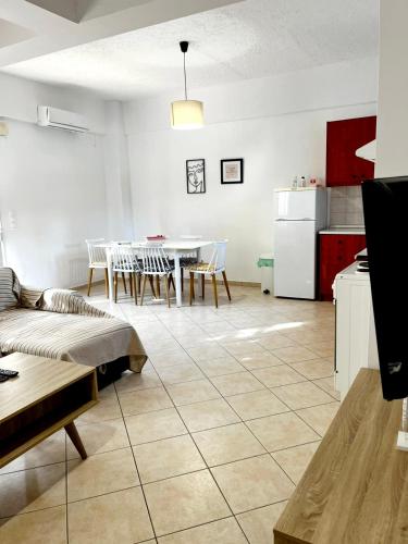 a kitchen and a living room with a table and a couch at "Villa Kanavos" apts in Matala