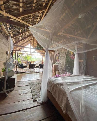 a bedroom with a bed with a mosquito net at Bayano Ecolodge in Chepo