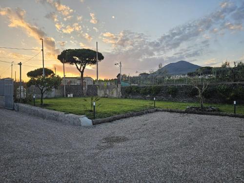 a parking lot with a field of grass and trees at Villa Cola - Vesuvio Garden & Relax in Boscotrecase