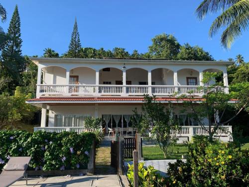 a large white house with a balcony at VILLA COLIBRI in Mon Repos