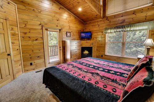 a bedroom with a bed in a wooden cabin at Mountain Treasure by Venture Smoky Mountains in Sevierville