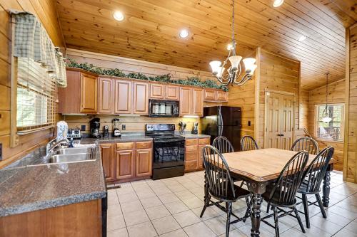 a kitchen with a table and chairs in a kitchen at Mountain Treasure by Venture Smoky Mountains in Sevierville