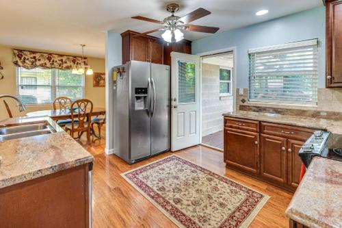 a kitchen with a stainless steel refrigerator and a dining room at 2 Mi to FSU and FAMU Home with Spacious Deck! in Tallahassee
