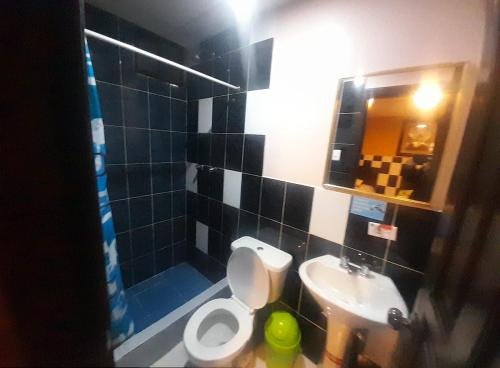 a bathroom with a toilet and a sink at HOSTAL CALIFORNIA in Quito