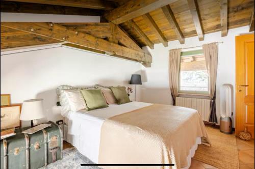 a bedroom with a white bed and a window at Casa Frida, penthouse on the lake in Lonato del Garda