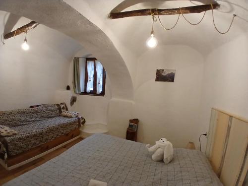a bedroom with two beds and a stuffed animal on the floor at B&B 8A CASTELBIANCO in Castelbianco
