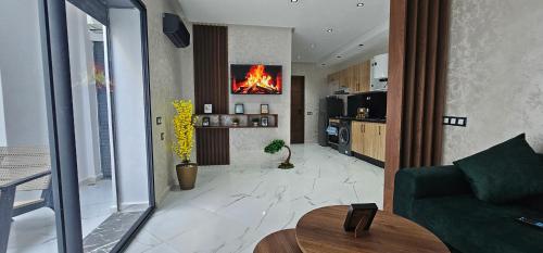 a living room with a fire painting on the wall at Superbe appartement , à deux pas de la plage in Plage de Mehdia
